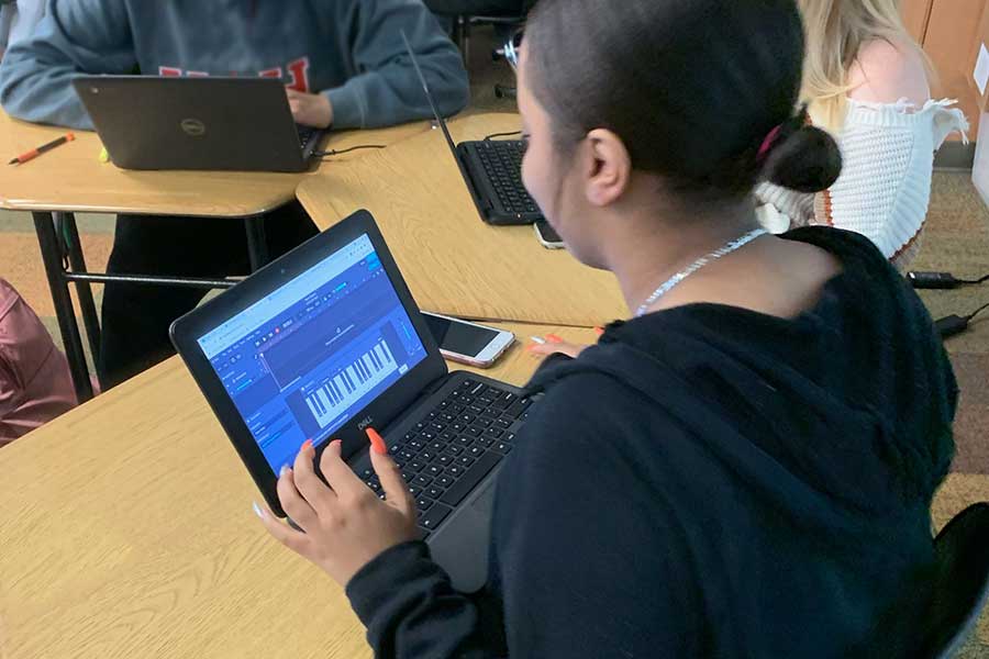 Several high school students in a classroom using Band Lab software on their computers