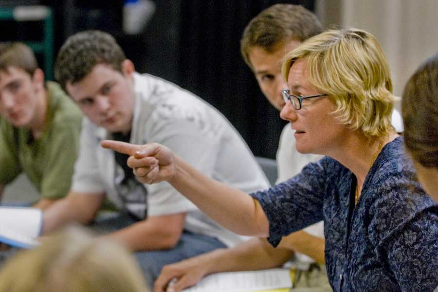 Photo of Barbara Pitts McAdams, teaching seated among a group of adult students